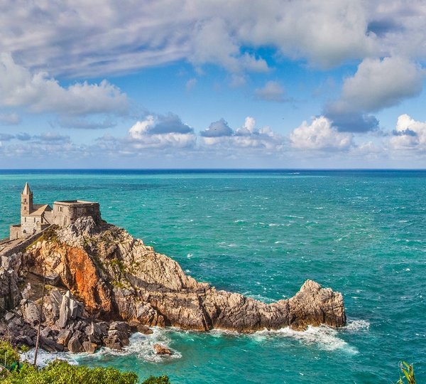 Gothic Church Of St Peter (Chiesa di San Pietro) with seagull on a rock in the town of Porto Venere Ligurian Coast province of La Spezia Italy