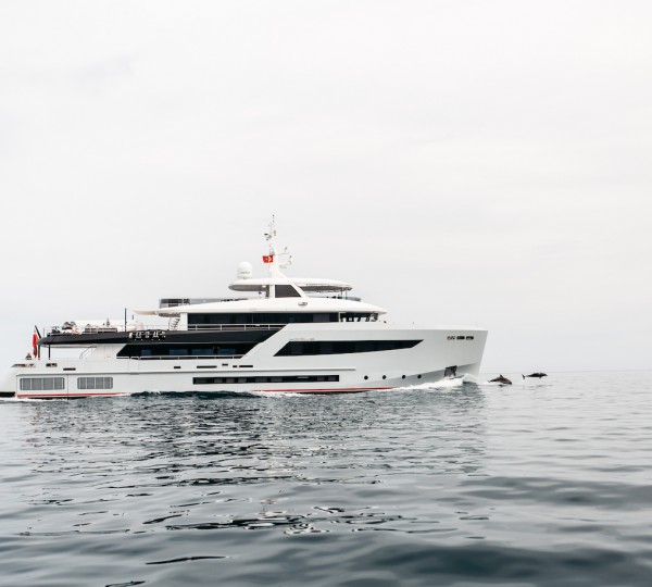 Yacht HEEUS Cruising With Dolphins