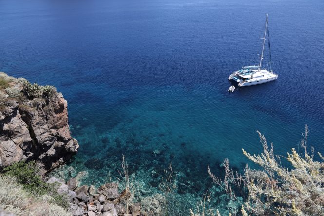 Exploring a private bay aboard a catamaran yacht